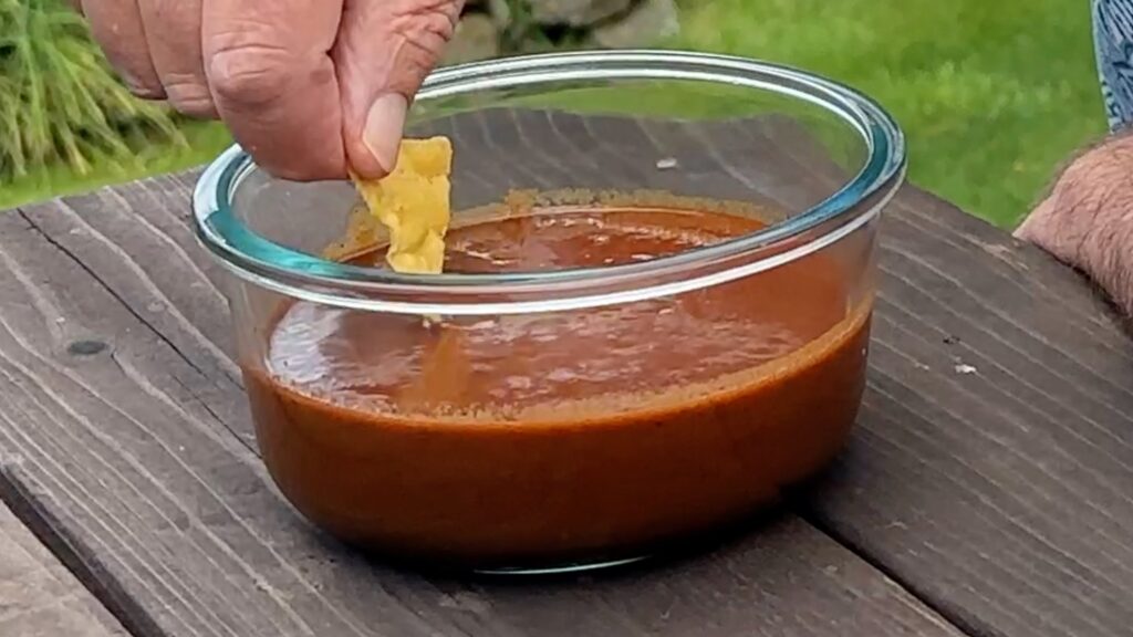 Photo of dipping a corn chip into a bowl of Morita Salsa