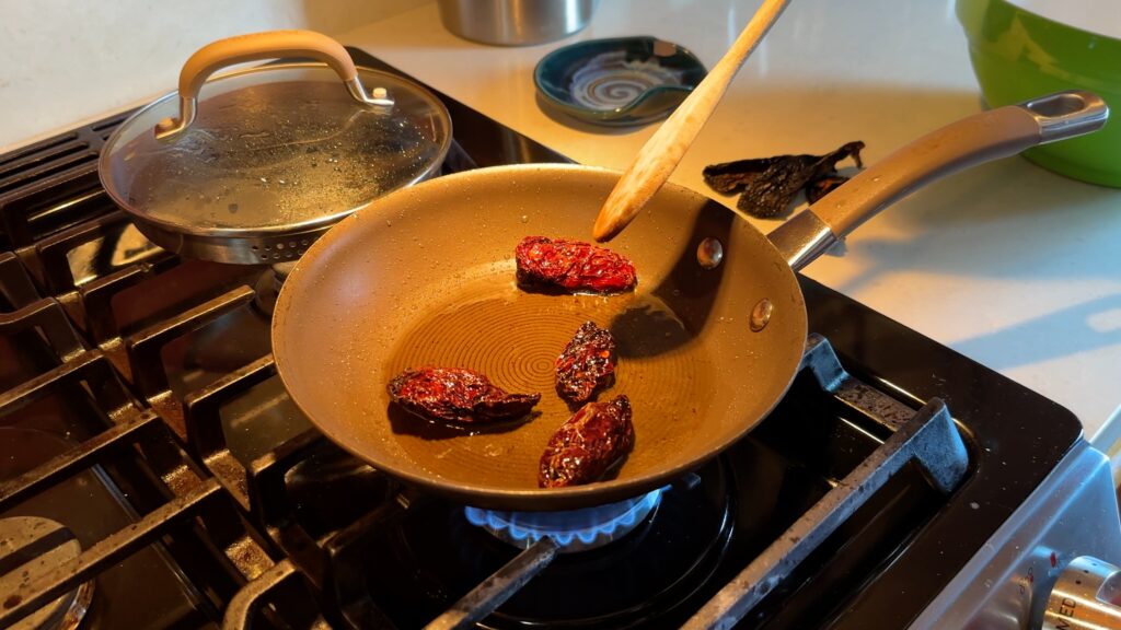 The Morita Chiles in the pan with oil, puffed up.