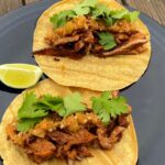 Photo shows two tacos on a plate