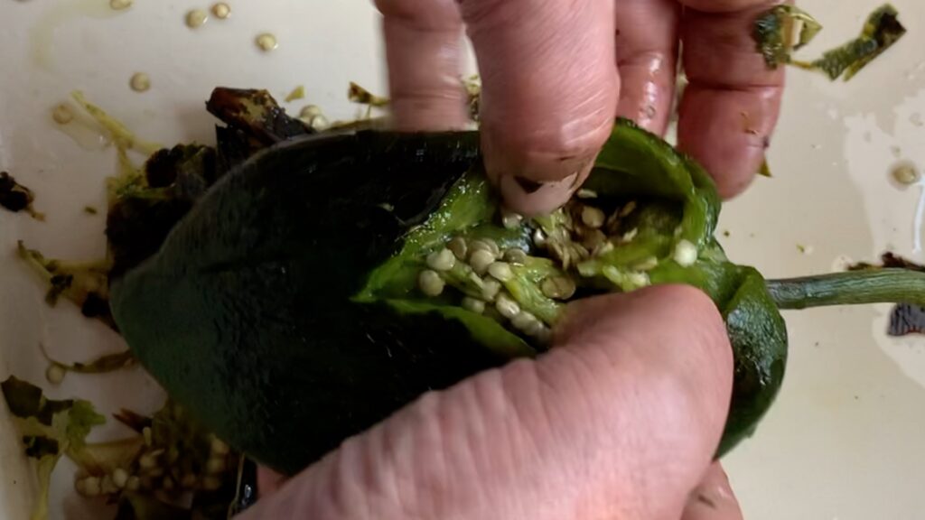 Photo shows peeled chile with a small slit for removing the seeds.