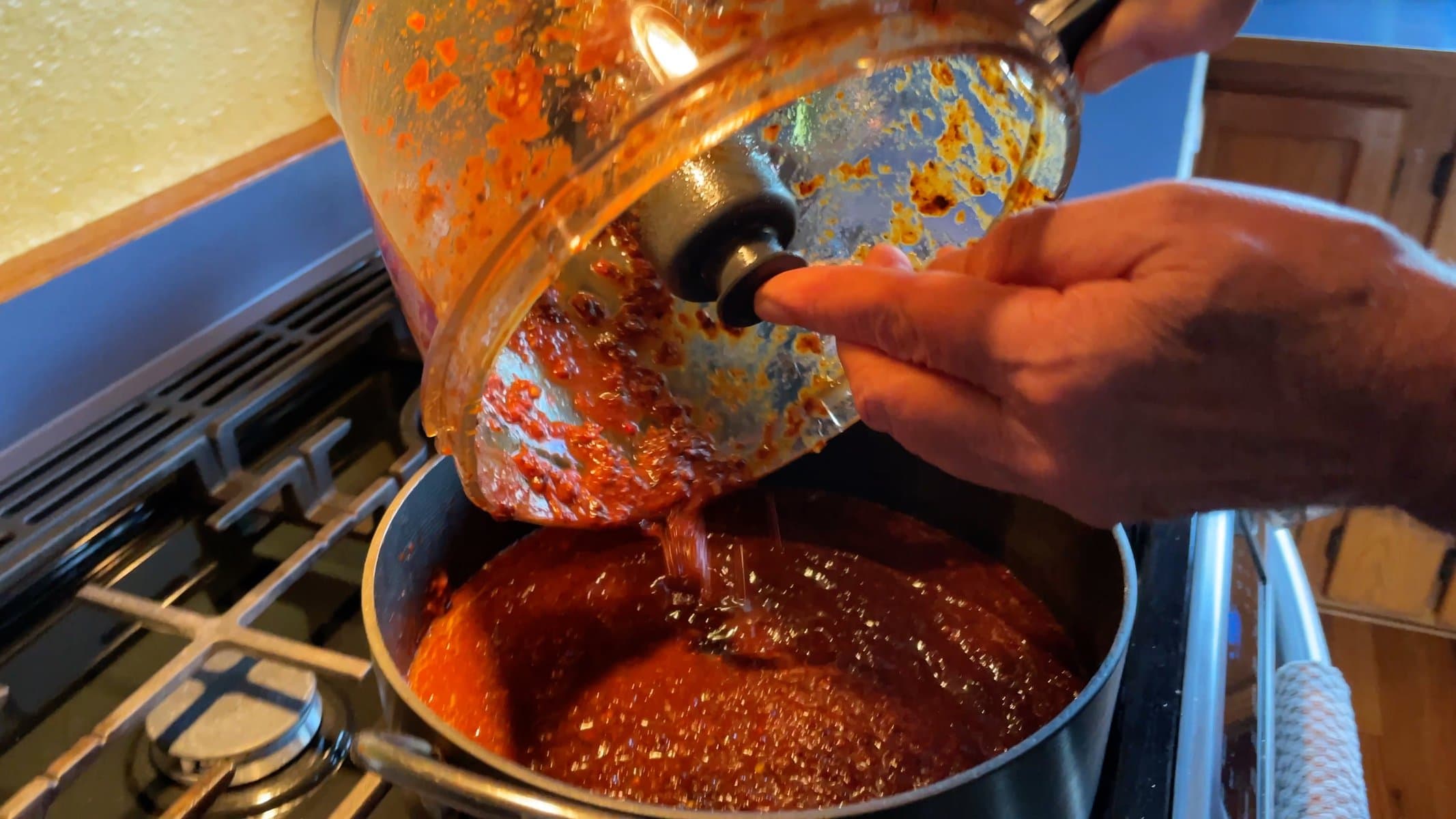 Pouring the sauce into hot oil in the pan