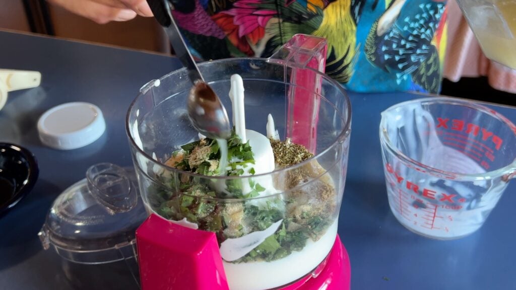 Photo shows lime juice going into the food processor