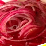 Photo shows bright pink onions in a yellow bowl