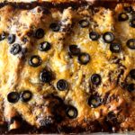 Photo shows a pan of molé enchiladas cooked