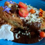 Photo shows a chile relleno with black molé