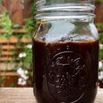 Photo shows a thick black sauce in a jar