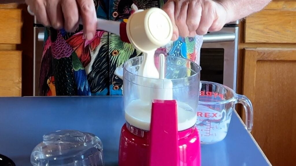 Photo shows buttermilk and sour cream in a small pink food processor.