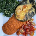 Photo shows the Roasted Red Pepper Sauce served with a stuffed green pepper