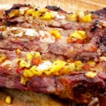 Photo shows BBQ Ribs With Pineapple Salsa cooked and cut
