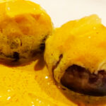 Photo shows Crab Stuffed Mushrooms With Yellow Curry Sauce all done with lemon pieces.