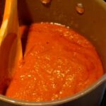 Photo shows the red curry paste done cooking in the pot