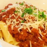 Photo shows a bowl of bolognese on gluten free pasta