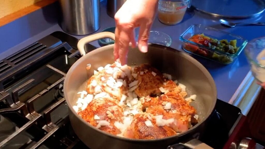 Photo shows the onions going into the pan