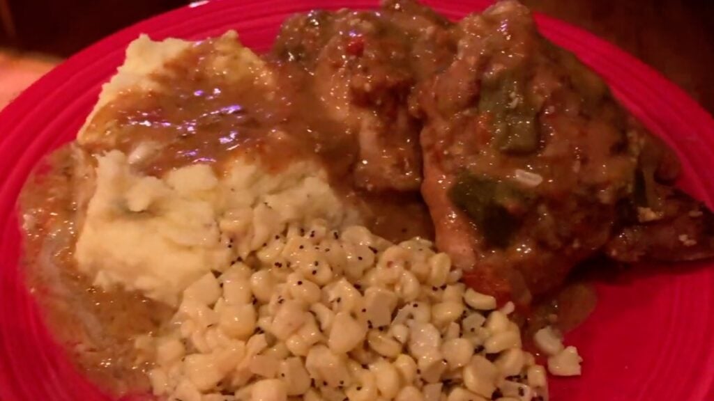 Green Chile Chicken plated with mashed potatoes and corn