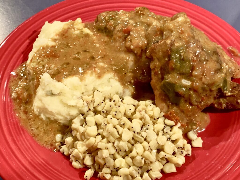 Photo shows Green Chile Chicken served with mashed potatoes and corn
