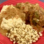 Photo shows Green Chile Chicken served with mashed potatoes and corn