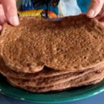 Photo shows several Injera stacked up on a plate.