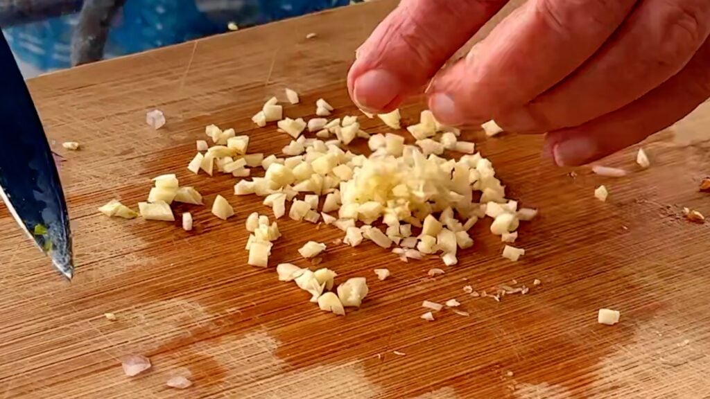 Photo shows the garlic being chopped