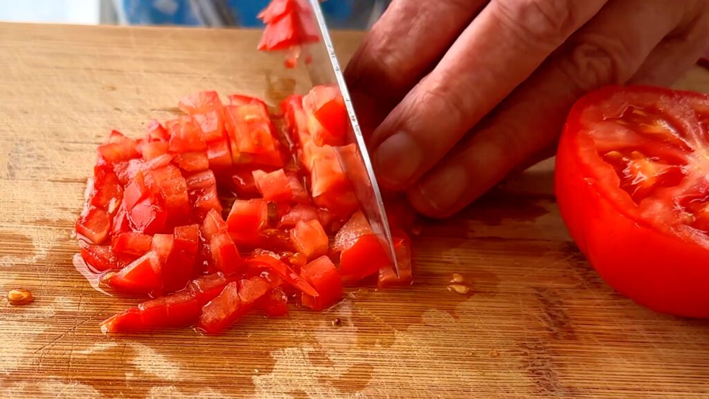Photo shows the tomato being diced