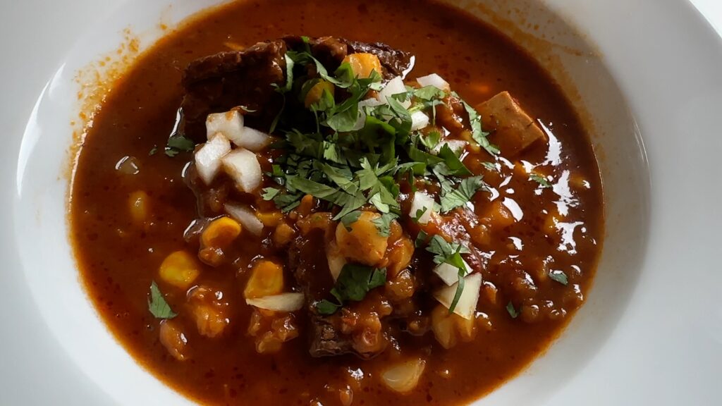 Photo shows a bowl of Beef Birria