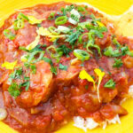 Photo shows Shrimp Picquante served on a yellow plate