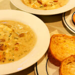 Photo shows seafood chowder with gluten free sourdough bread.